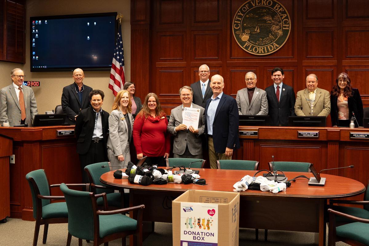 Museum officials hold proclamation from City Council at City Hall chambers